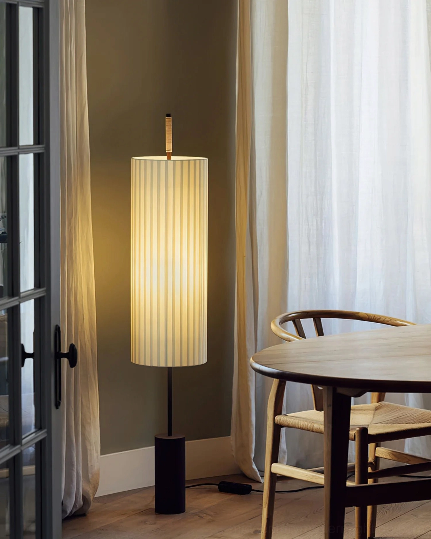 Dorica modern sculptural floor lamp providing soft ambient lighting in casual dining corner