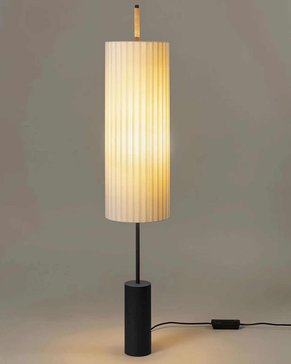 Dorica pleated floor lamp close-up showing fabric texture and slim black pole design