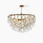 Doris antique brass crystal chandelier with cascading glass drops, front view against white backdrop showing organic twig frame and ten G9 sockets