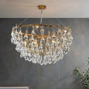 Luxury Doris brass chandelier overhead view displaying layered crystal drop tiers and warm prismatic light refraction in contemporary dining room