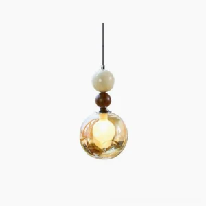 Dot pendant light with cognac amber glass sphere and walnut wood bead accents on white studio background, front overhead view