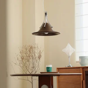 Dottie pendant light in warm dining room setting above minimalist side table with retro aesthetic