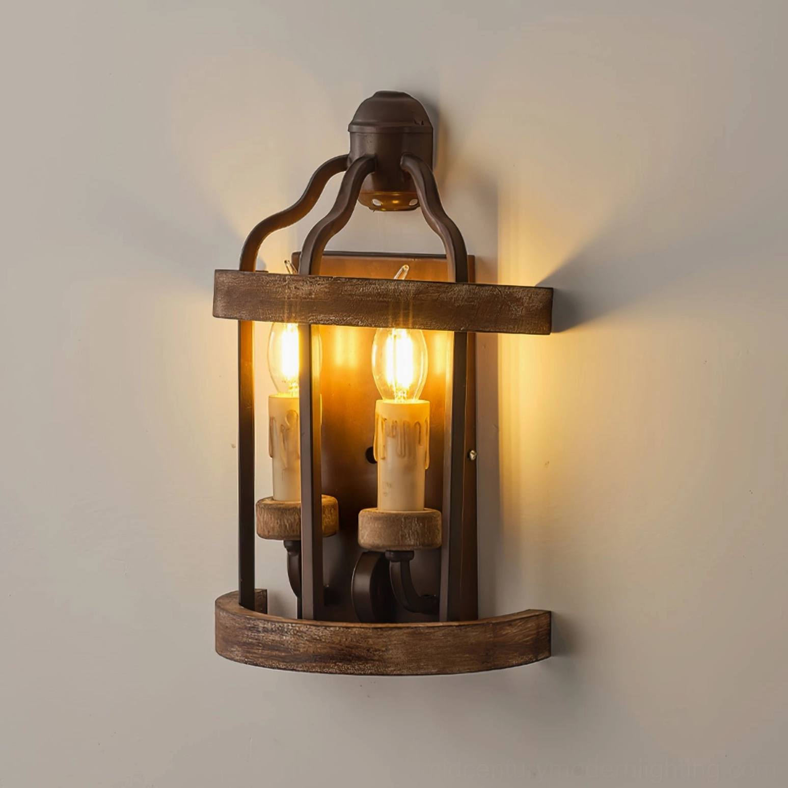 Close-up view of double candle wall lamp with illuminated vintage Edison-style bulbs on off-white wall