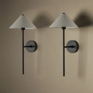 Twin cedar black wall sconces mounted symmetrically on warm beige wall, demonstrating paired installation for bedroom or living room accent lighting