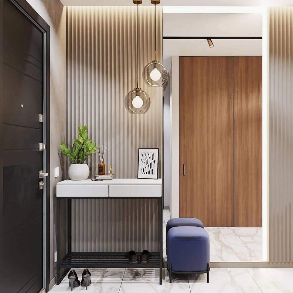 Modern residential entryway with two hanging smoked glass pendant lights in warm home interior, brass metal accents