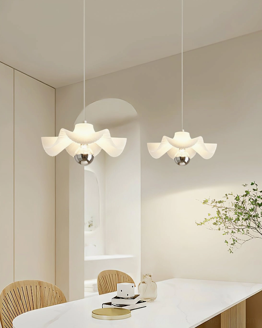 Two sculptural pleated pendant lights in coordinated dining room with arched archway