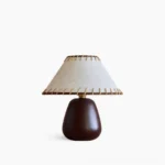 Douglas walnut table lamp with beige linen whipstitch shade on clean white background, mid-century modern design