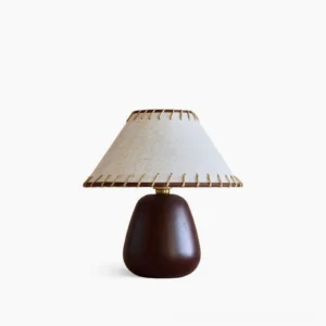 Douglas walnut table lamp with beige linen whipstitch shade on clean white background, mid-century modern design