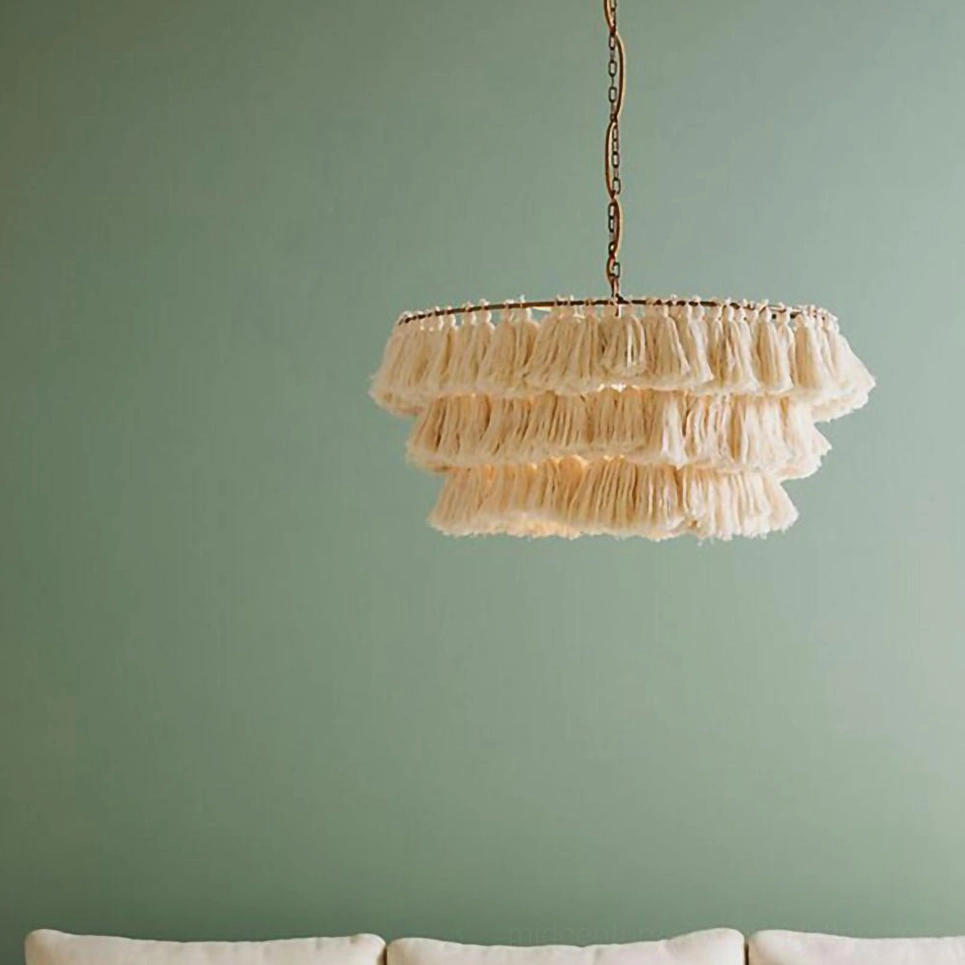 Large dramatic tassel chandelier with generous layering in eclectic bohemian entryway installation