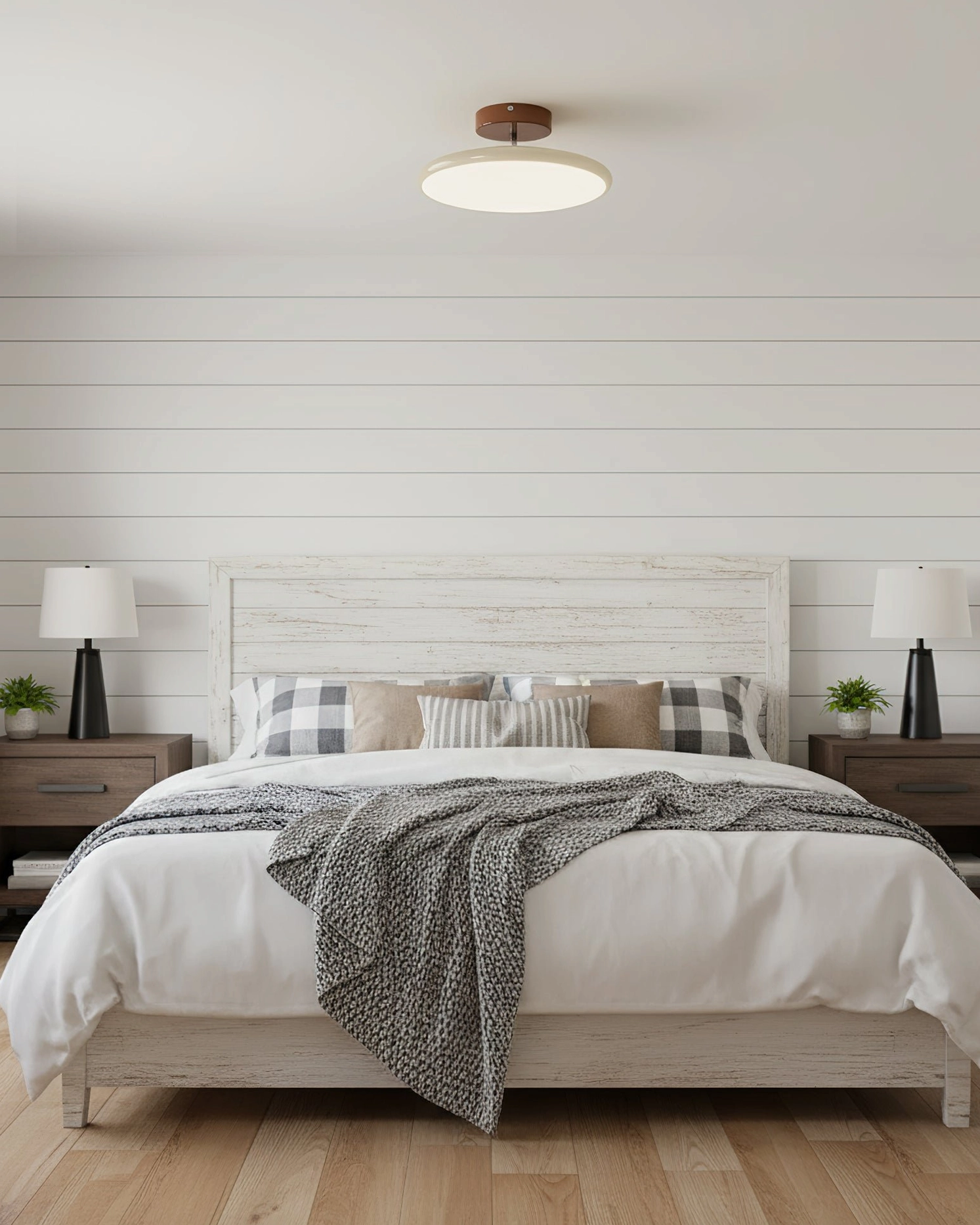 Drift disc ceiling fixture in master bedroom with neutral bedding and minimalist design aesthetic