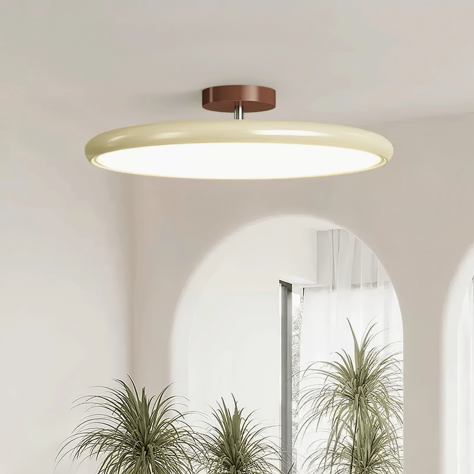 Drift ceiling lamp in cream finish with arched doorway and potted plants in minimalist space