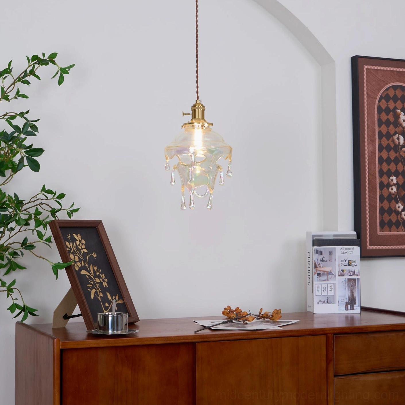 Drip resin pendant lamp with brass crown mounted in contemporary interior space