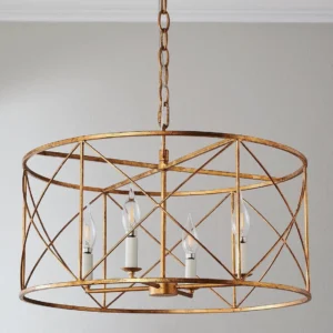 Distressed gold drum cage chandelier installed on residential ceiling, three-quarter angle showing interior candle bulbs and cylindrical frame