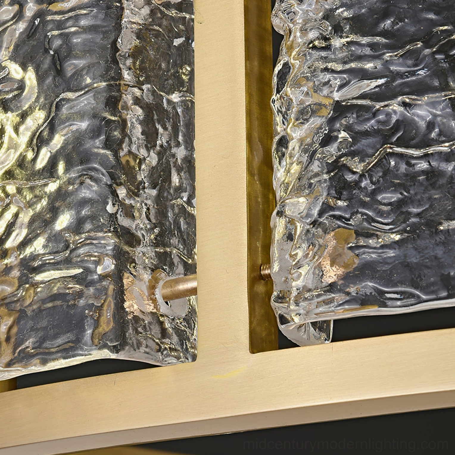 Close-up drum chandelier water-textured glass and brushed brass metal frame detail