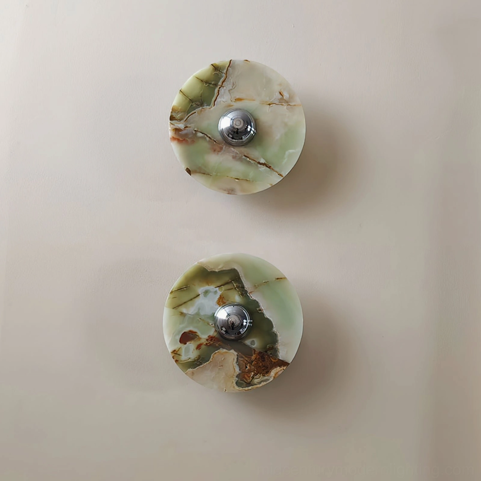 Pair of Alba green marble wall sconces displayed side by side demonstrating matching sculptural design and symmetrical placement