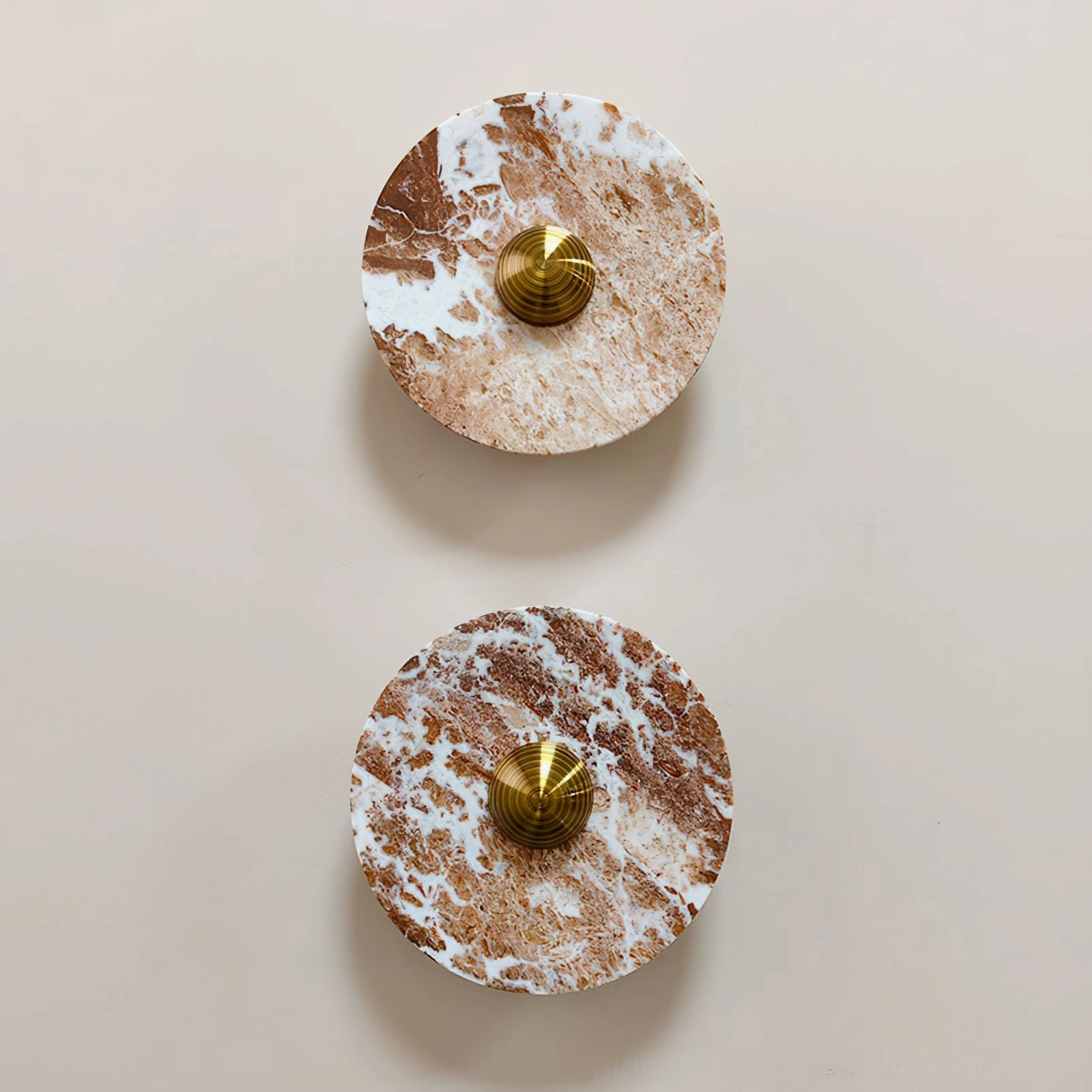 Pair of Aurora red marble wall sconces arranged symmetrically, overhead view showing circular form