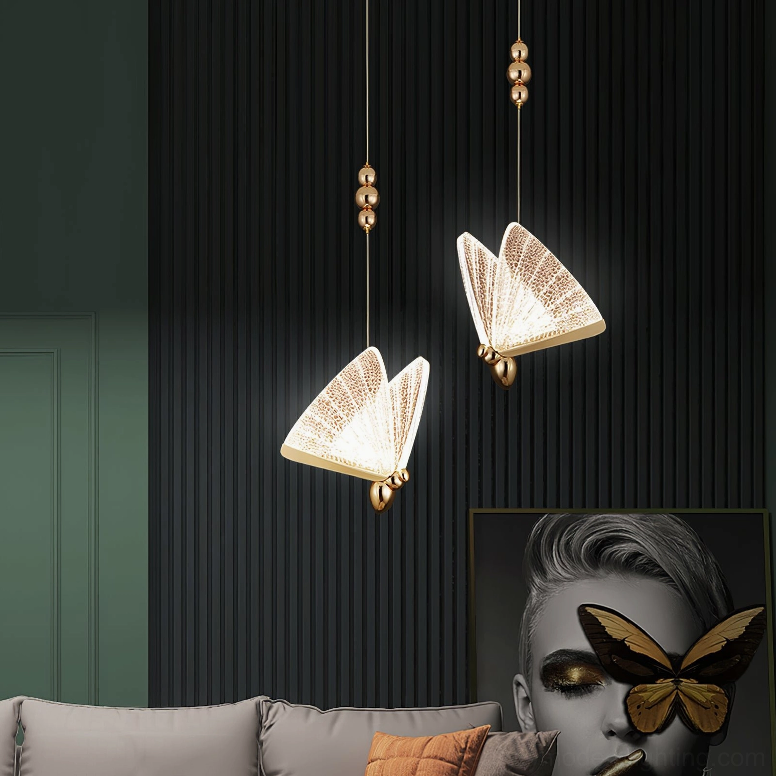 Two butterfly pendant lights above living room area with butterfly wall art and gold fixtures
