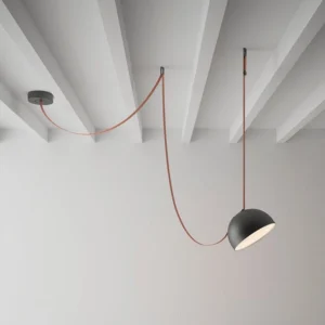 Modern leather cord pendant fixture with dual hemispheres installed in minimalist Nordic interior with exposed ceiling