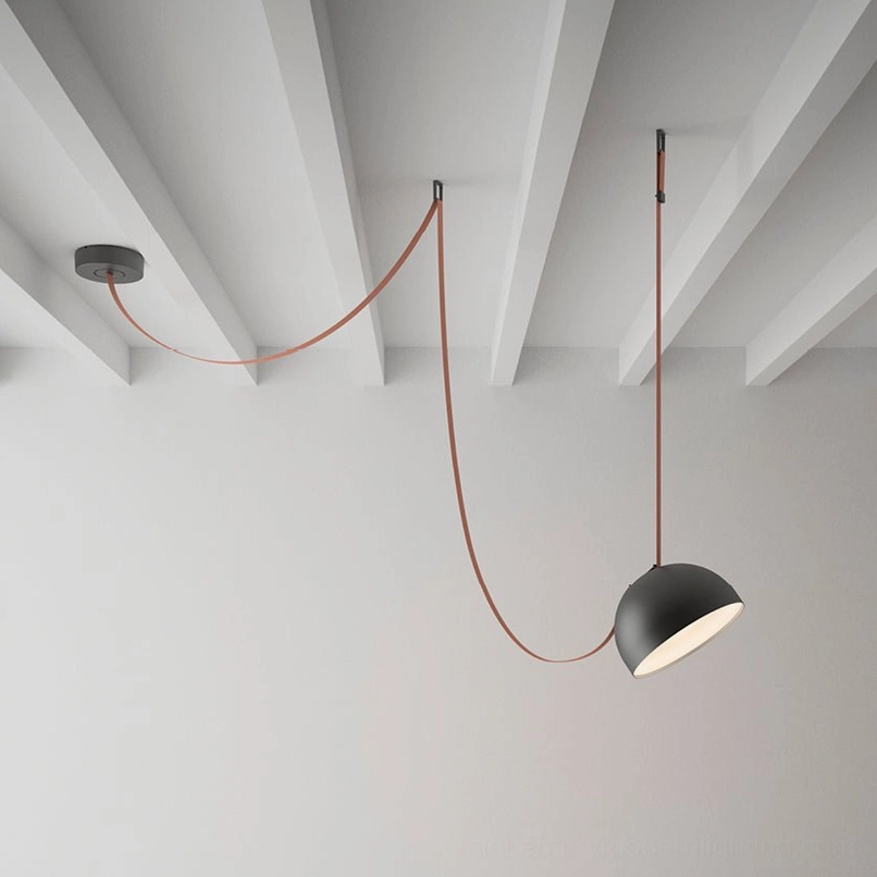Modern leather cord pendant fixture with dual hemispheres installed in minimalist Nordic interior with exposed ceiling