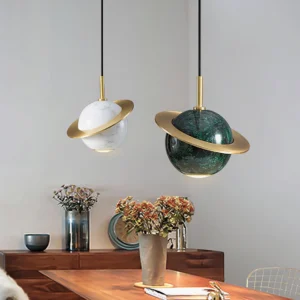 Two marble sphere pendant lights installed in dining room, white and dark green marble variants with warm brass accents