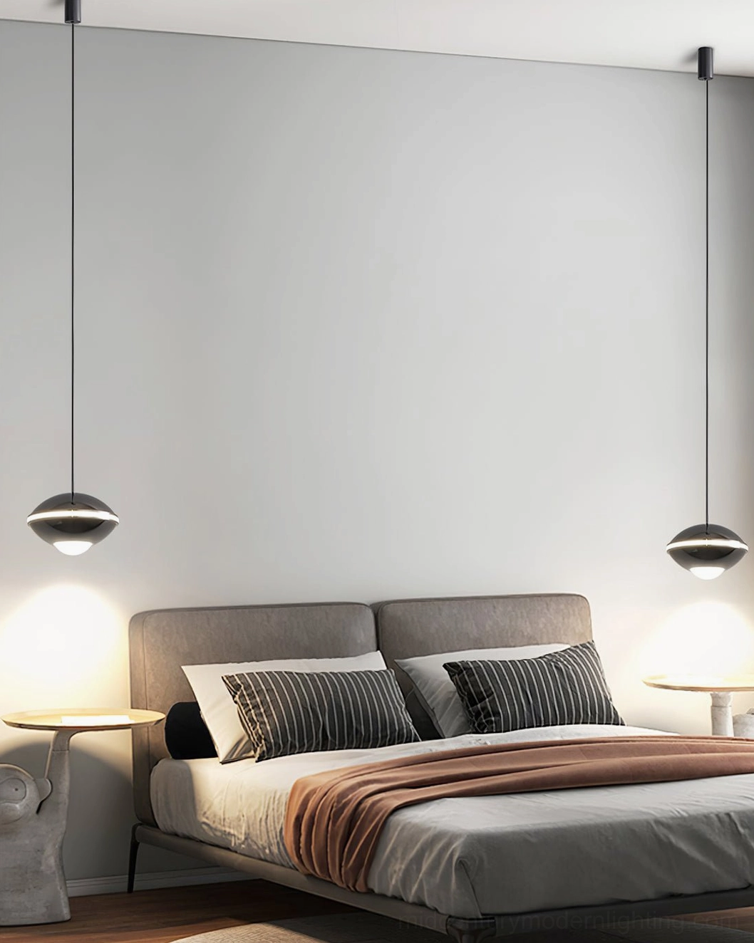 Dual modern pendant ceiling lights above bed, matching dark metal shades, bedside ambient lighting