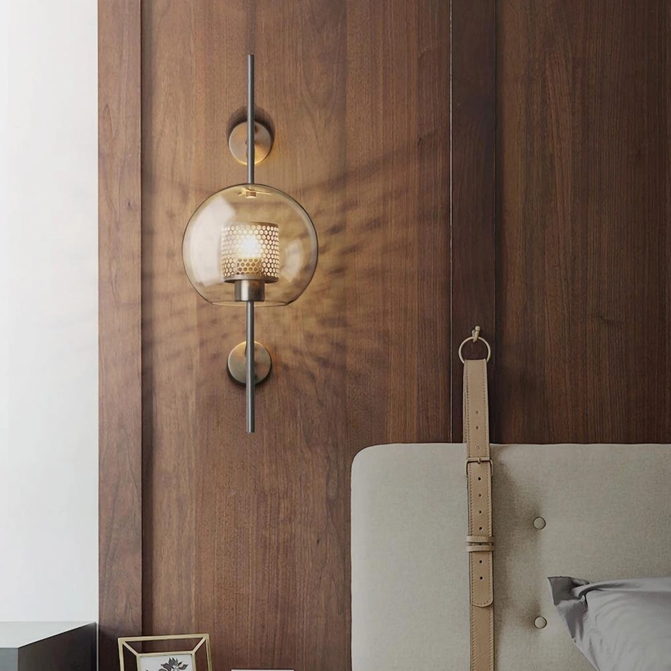 Symmetrical dual sphere glass wall lamps with brass fixtures and mesh shade, front view