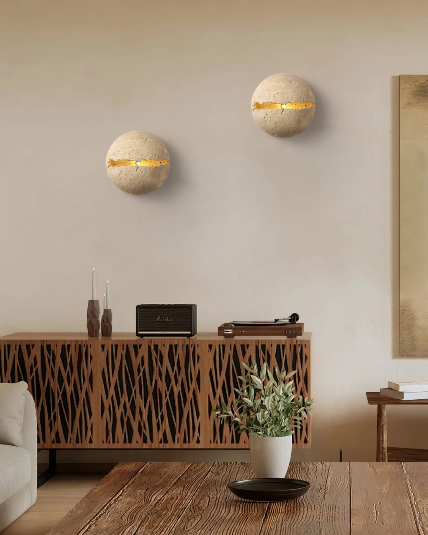 Dual travertine round wall lamps providing ambient lighting in modern living room with neutral styling