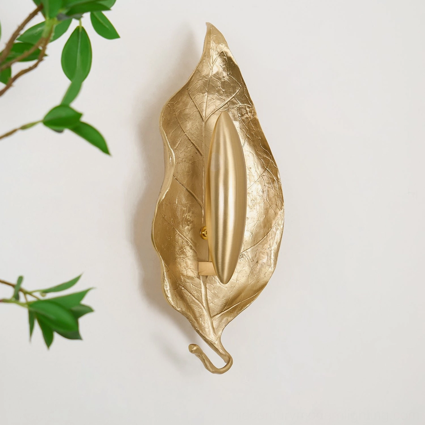 Dumaine leaf wall sconce three-quarter left view on white wall showing exposed mounting hardware and stem architecture