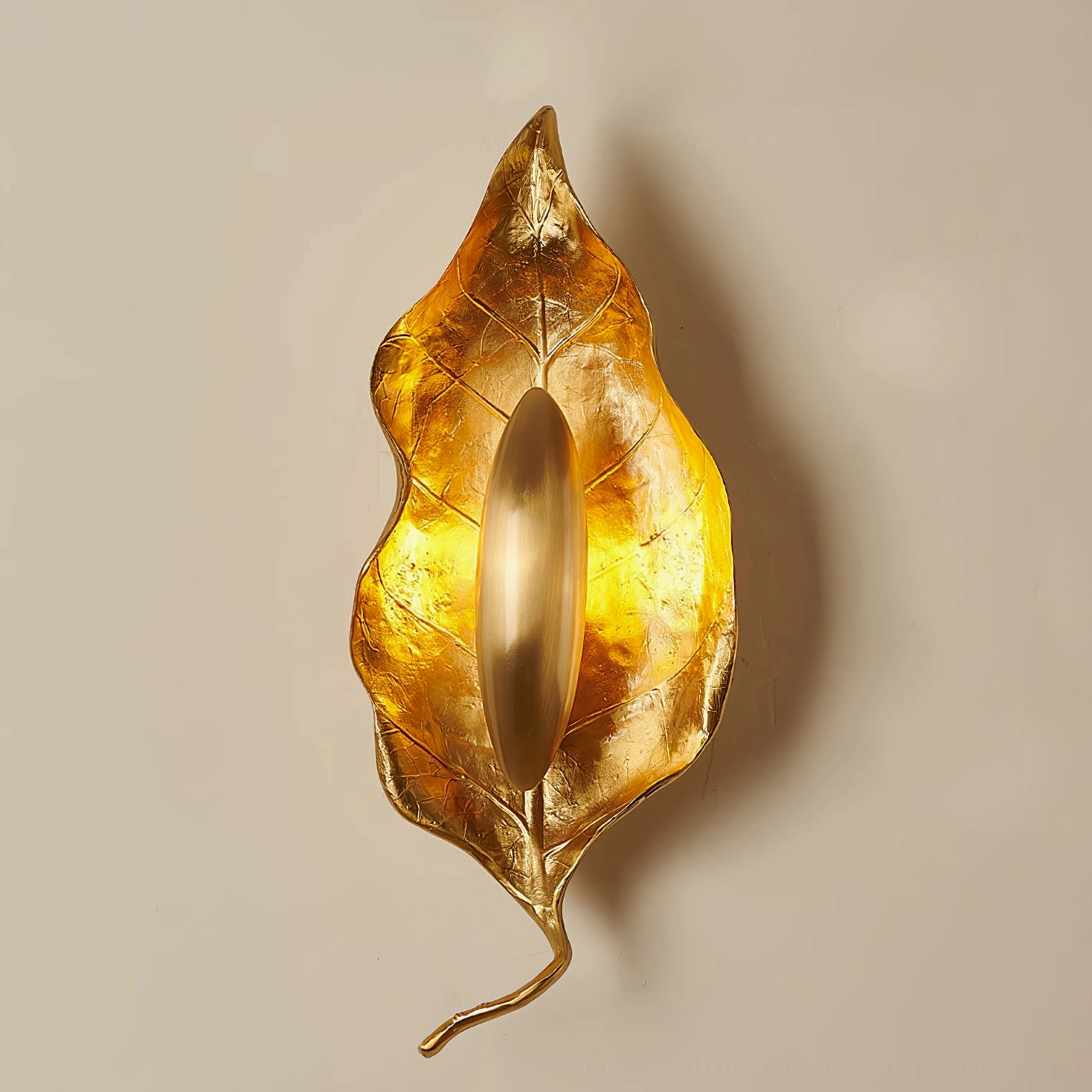 Modern Dumaine brass leaf wall sconce in bedroom setting creating intimate ambient lighting atmosphere