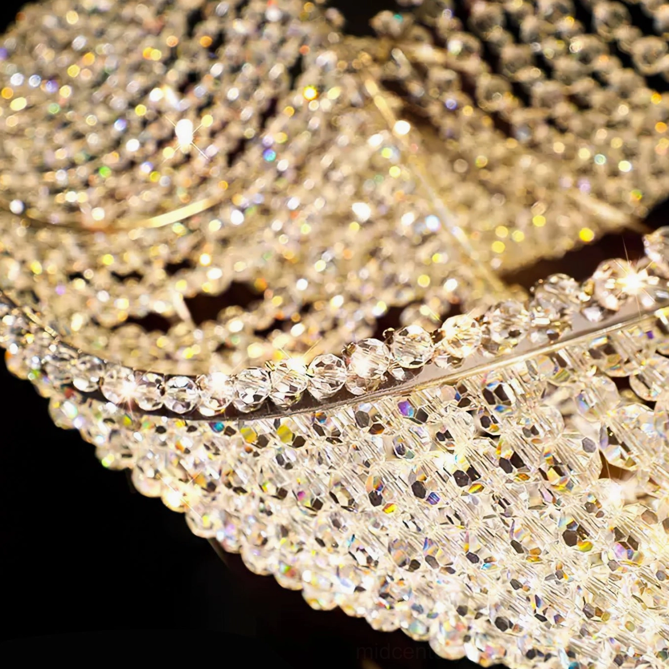 Dumini wave chandelier warm-lit crystal string detail with soft light reflection