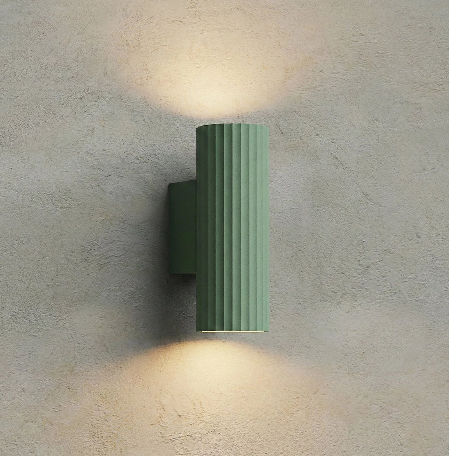 Dunbar green wall light with dual upward and downward beam illumination on concrete wall, modern minimalist lighting