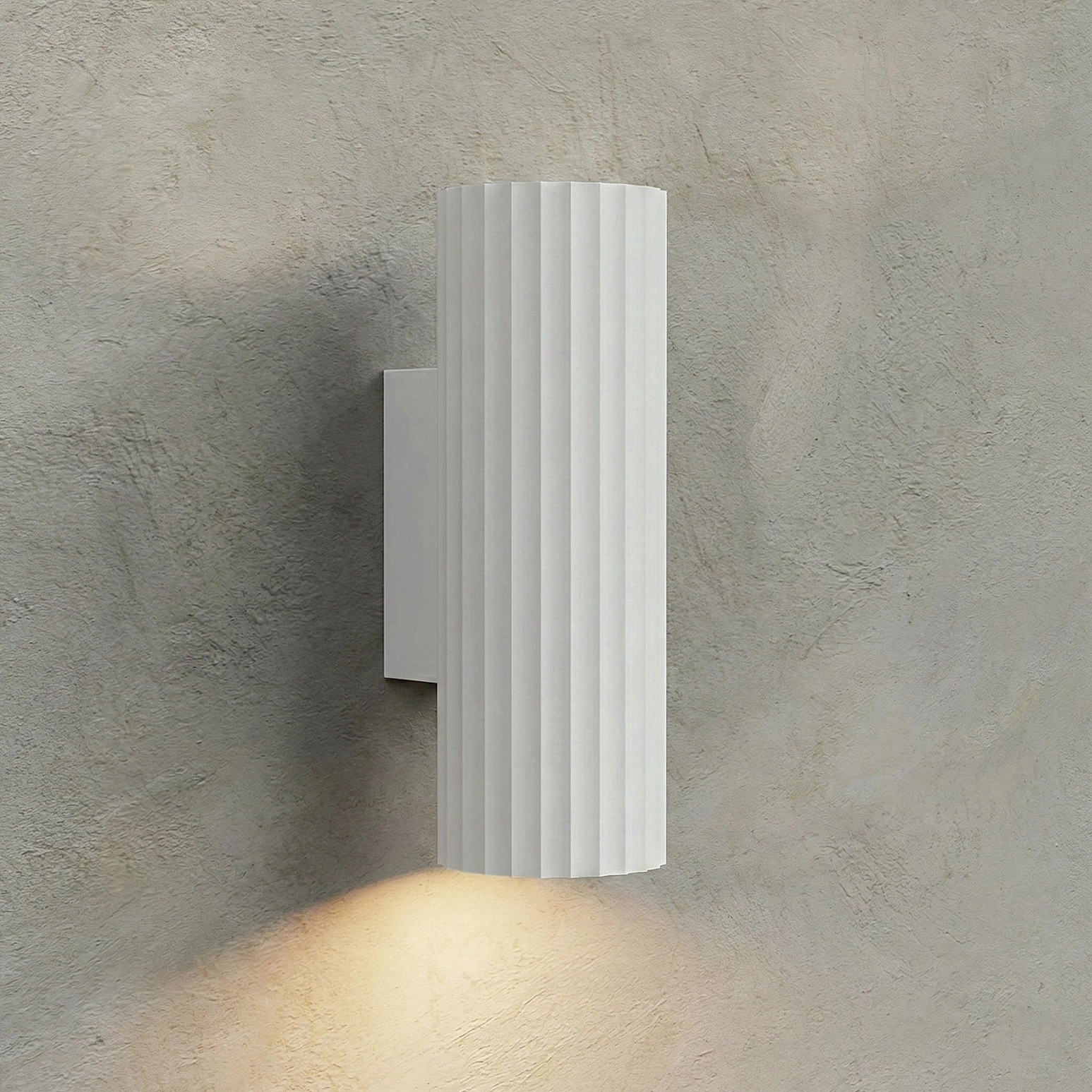 White Dunbar ribbed cylinder wall sconce with warm accent lighting, clean minimalist matte aluminum finish
