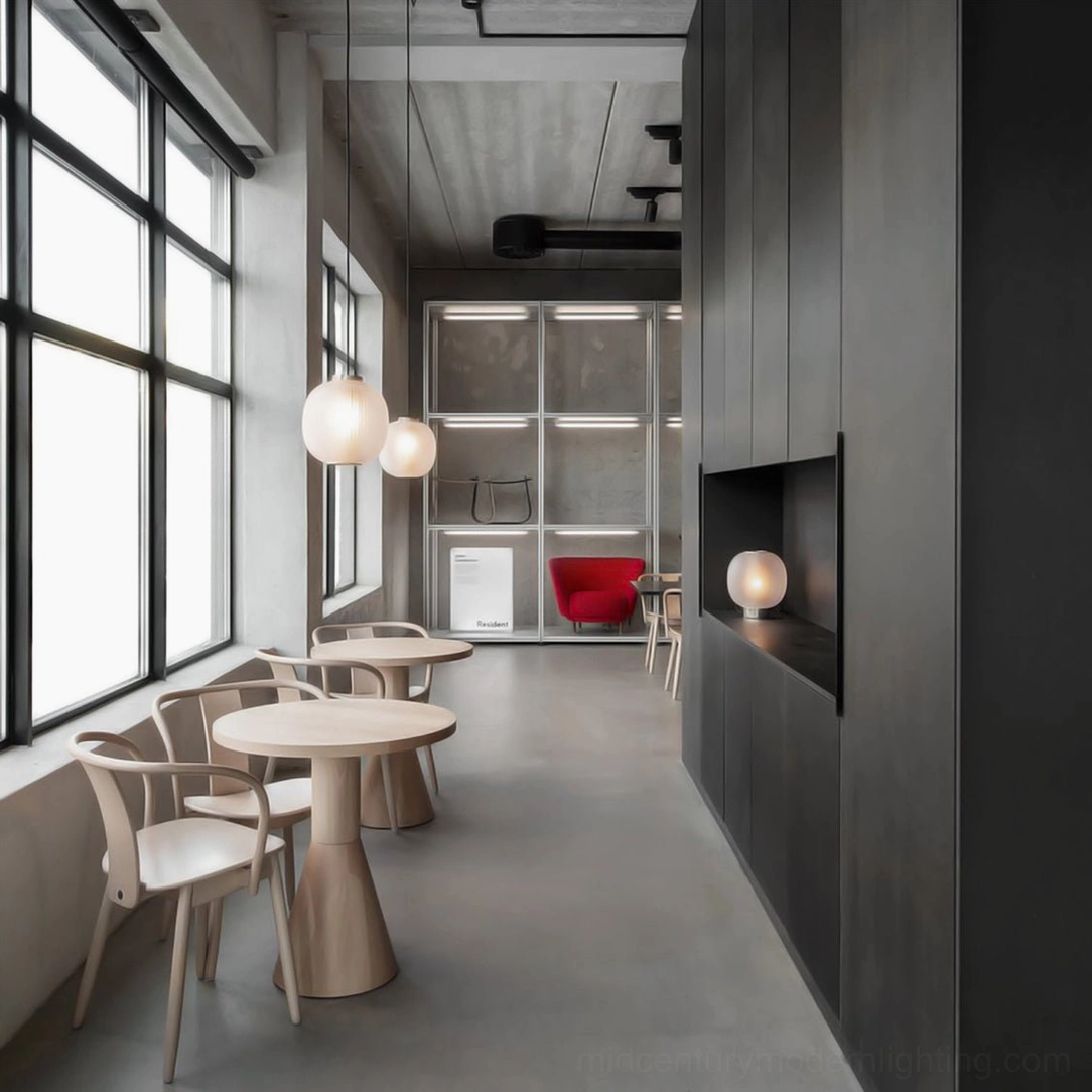 Multiple beige pendant lights in industrial minimalist cafe with concrete ceiling