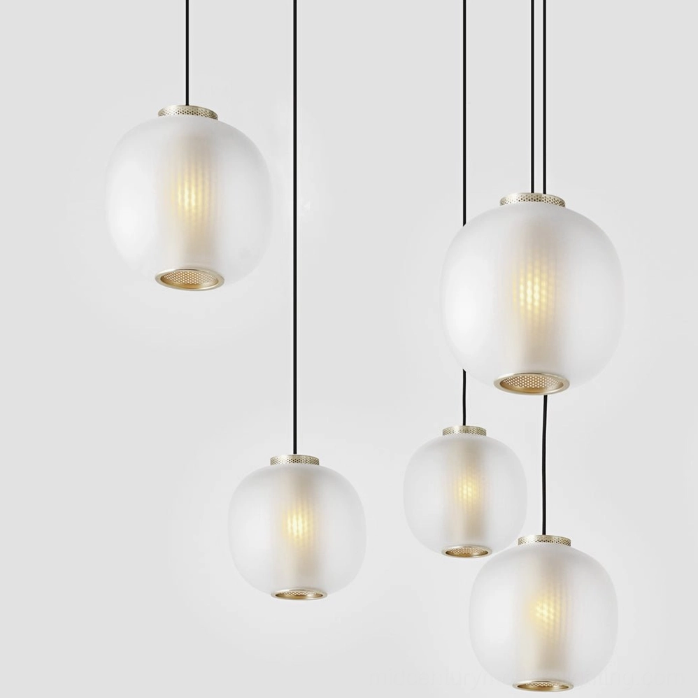 Frosted glass pendant light illuminated showing soft diffused glow and mesh silhouette