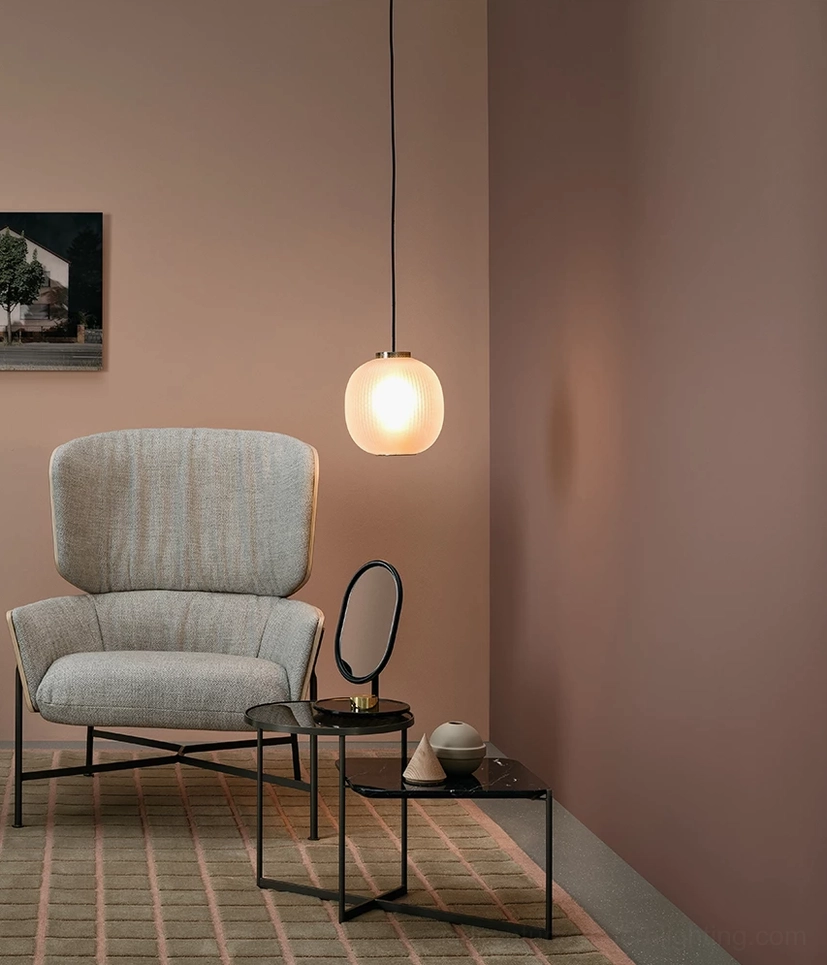 Smooth beige spherical pendant light in Scandinavian lounge with accent chair