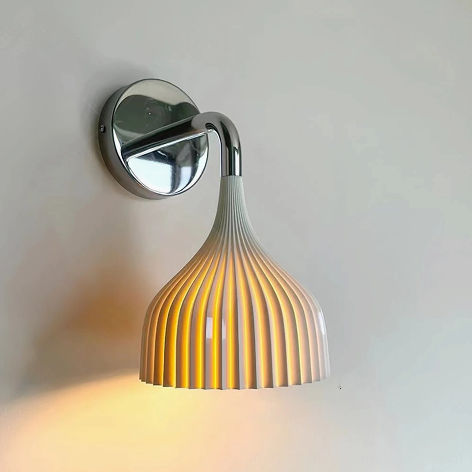 Amber ribbed glass wall lamp with chrome curved arm on light gray wall background