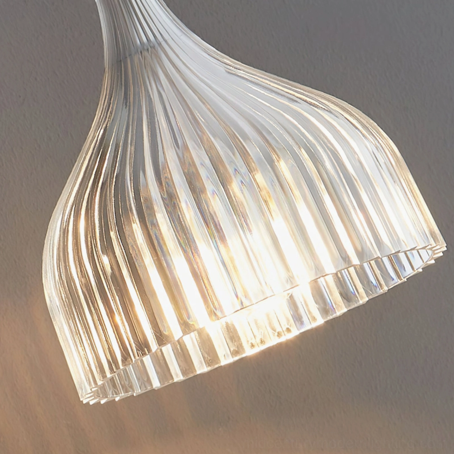 Close-up overhead view of clear ribbed glass lamp shade with warm light diffusion
