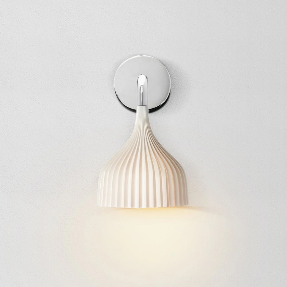 White ribbed glass wall lamp with round polished chrome wall plate, studio photography
