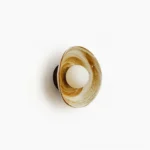 Eala ceramic wall lamp side view with marbled brown and white glaze, frosted glass bulb, modern sculptural design