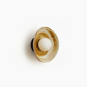 Eala ceramic wall lamp side view with marbled brown and white glaze, frosted glass bulb, modern sculptural design