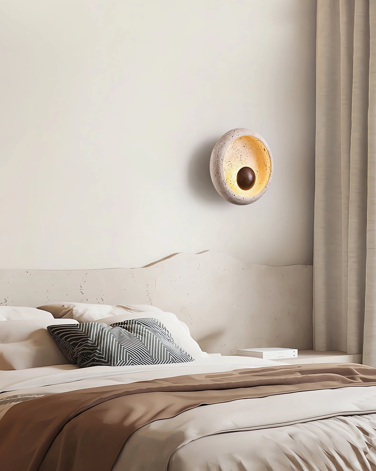Eala travertine wall lamp installed above bed in master bedroom setting
