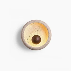 Eala travertine wall lamp front view with natural stone texture on white background