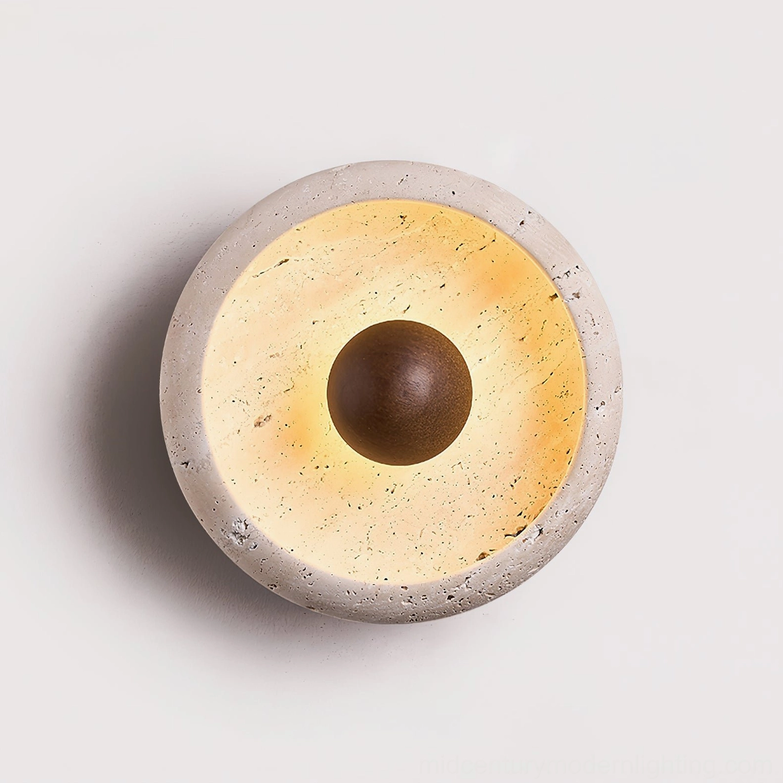 Close-up detail of travertine wall lamp showing natural porous stone texture