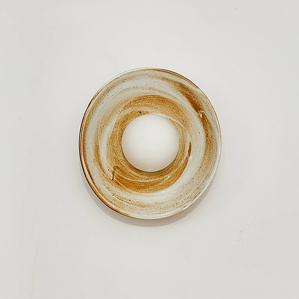 Eala wall lamp front view with concentric marbled ceramic glaze and central frosted glass orb