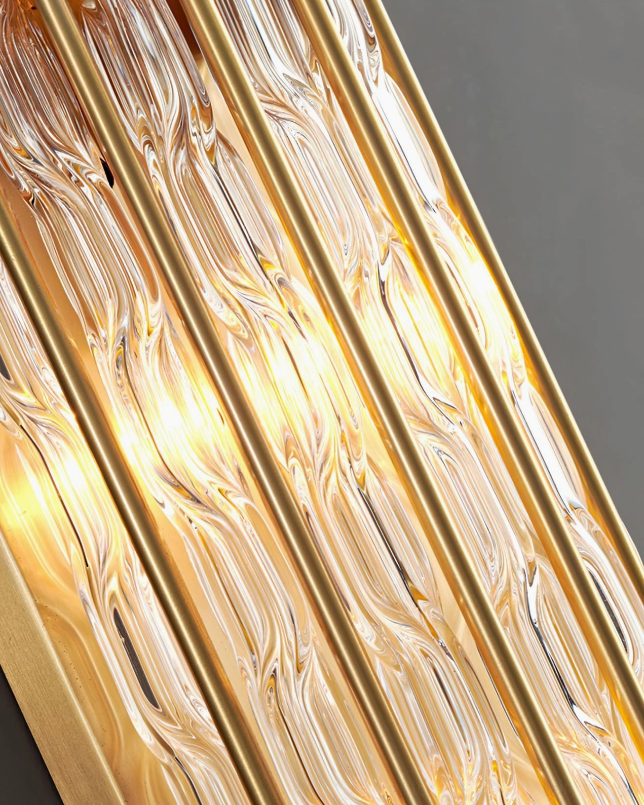 Contemporary brass and glass wall light fixture, polished finish with vertical ribbed glass diffuser
