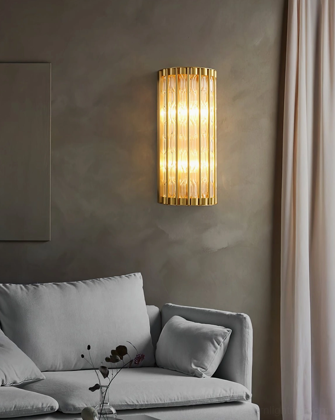 Cozy modern living room with warm ambient linear wall lamp, brass and fluted glass sconce design