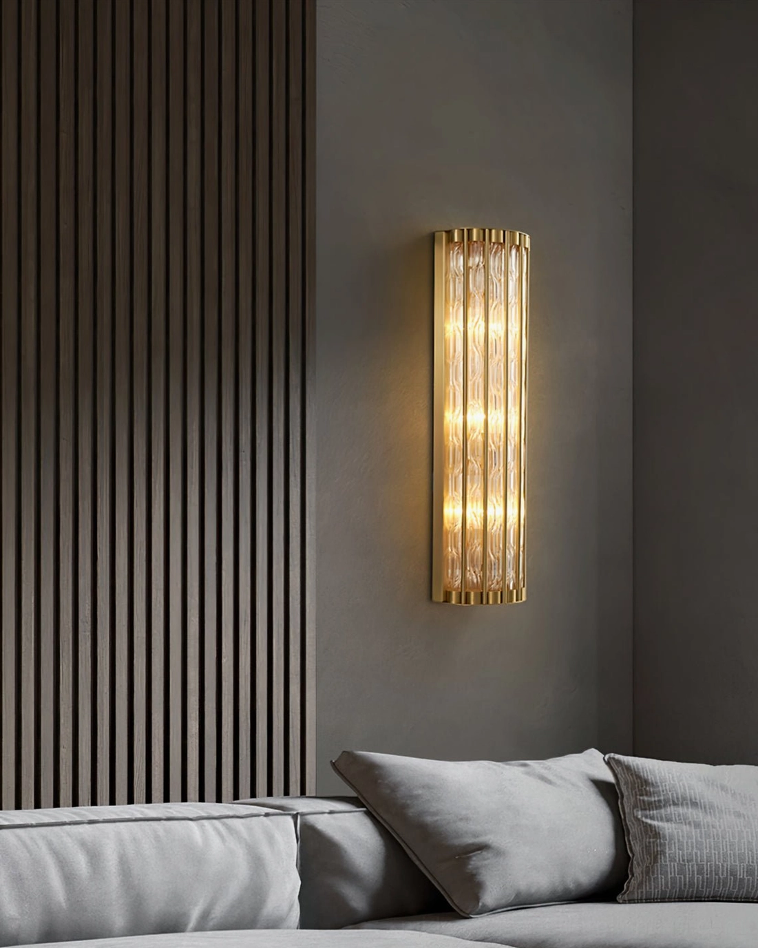 Vertical strip wall lamp with polished brass frame in contemporary living room with slatted accent wall