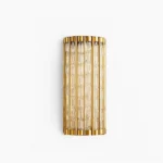 Eaton Linear brass wall sconce with ribbed glass cylinder, front studio view showing polished brass frame and fluted glass diffuser