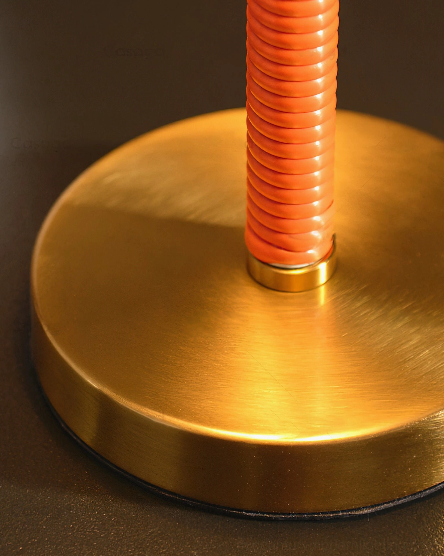 Eave table lamp base and stem detail, brushed brass gold round base with orange corrugated metal stem and hardware