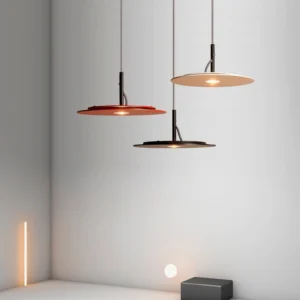 Eaves pendant lights in mixed colors including red black and neutral tones installed in minimalist corner space